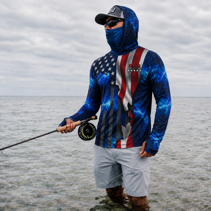 Angler wearing the USA Fishing Hoodie with face shield up, fly fishing the flats