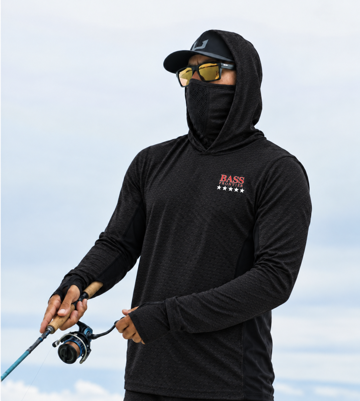 BassFrontier Black Fishing Hoodie: Angler wearing the hoodie with face covering and thumbhole cuffs