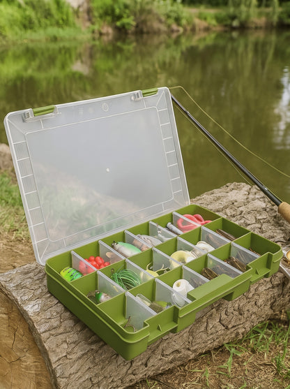 Fishing tool box loaded with lures on the bank next to a fishing rod